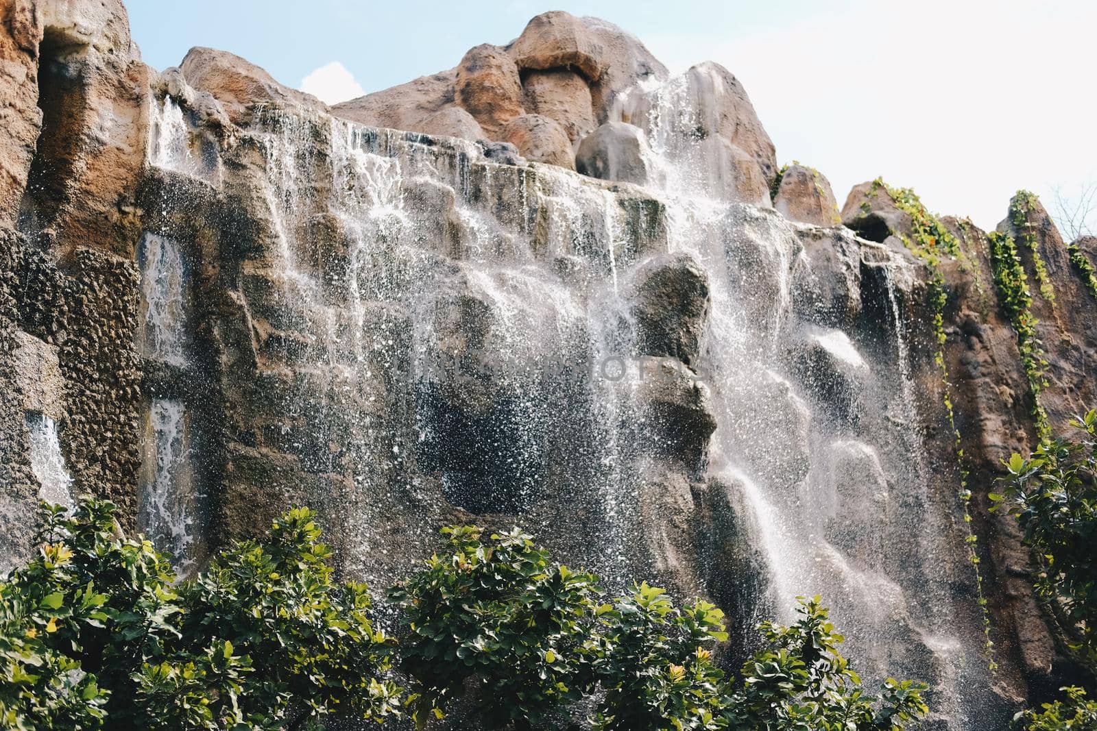 manmade waterfall park. flowing water stream