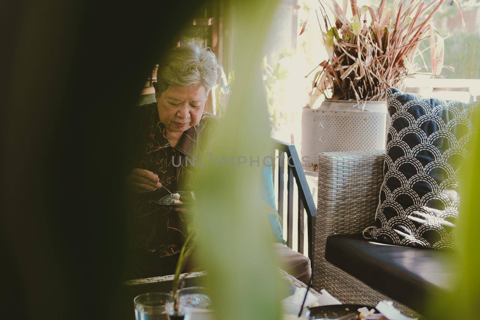 old asian elderly senior elder woman eating cheesecake at home