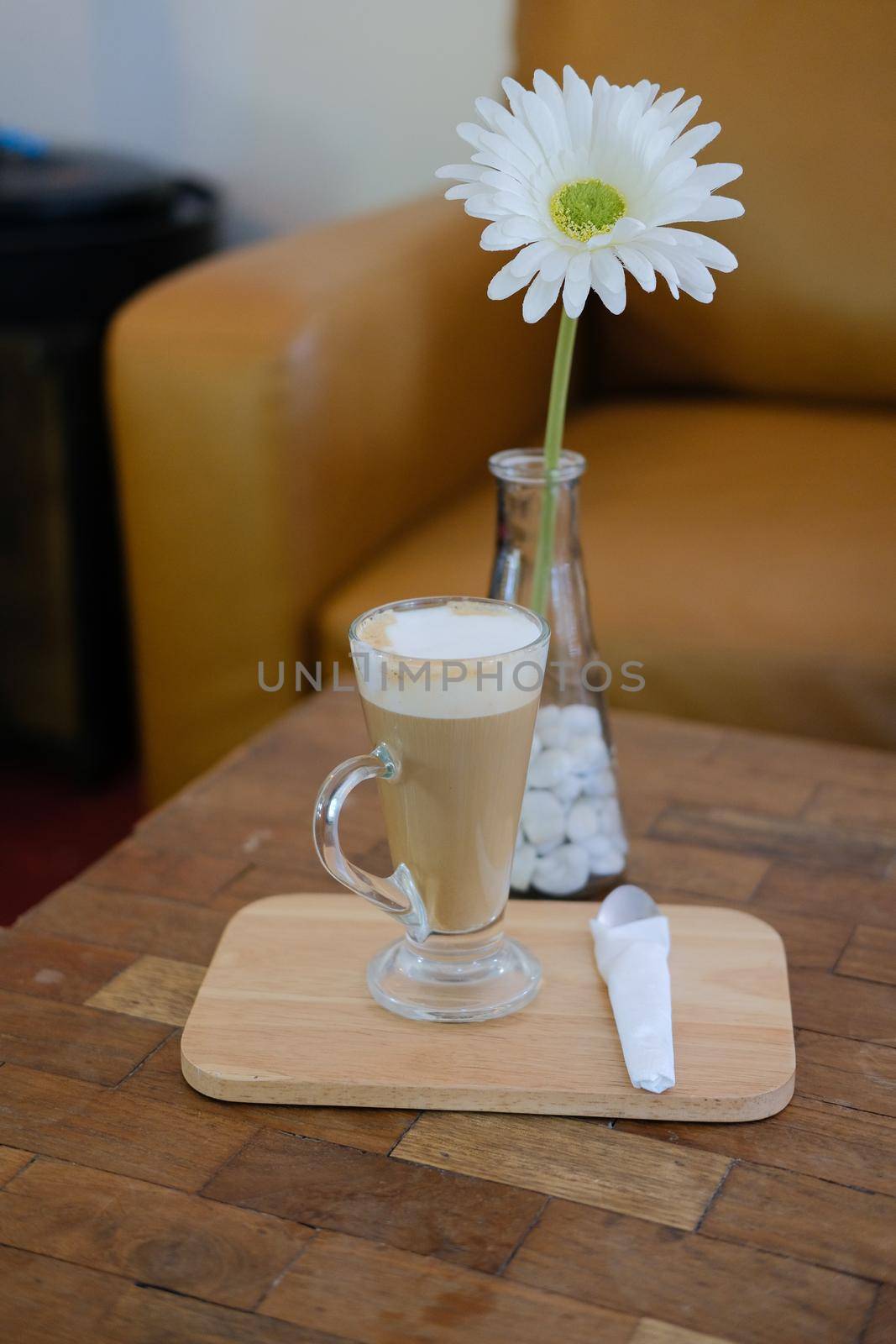 artificial white gerbera flower with hot latte cappuccino mocha coffee.