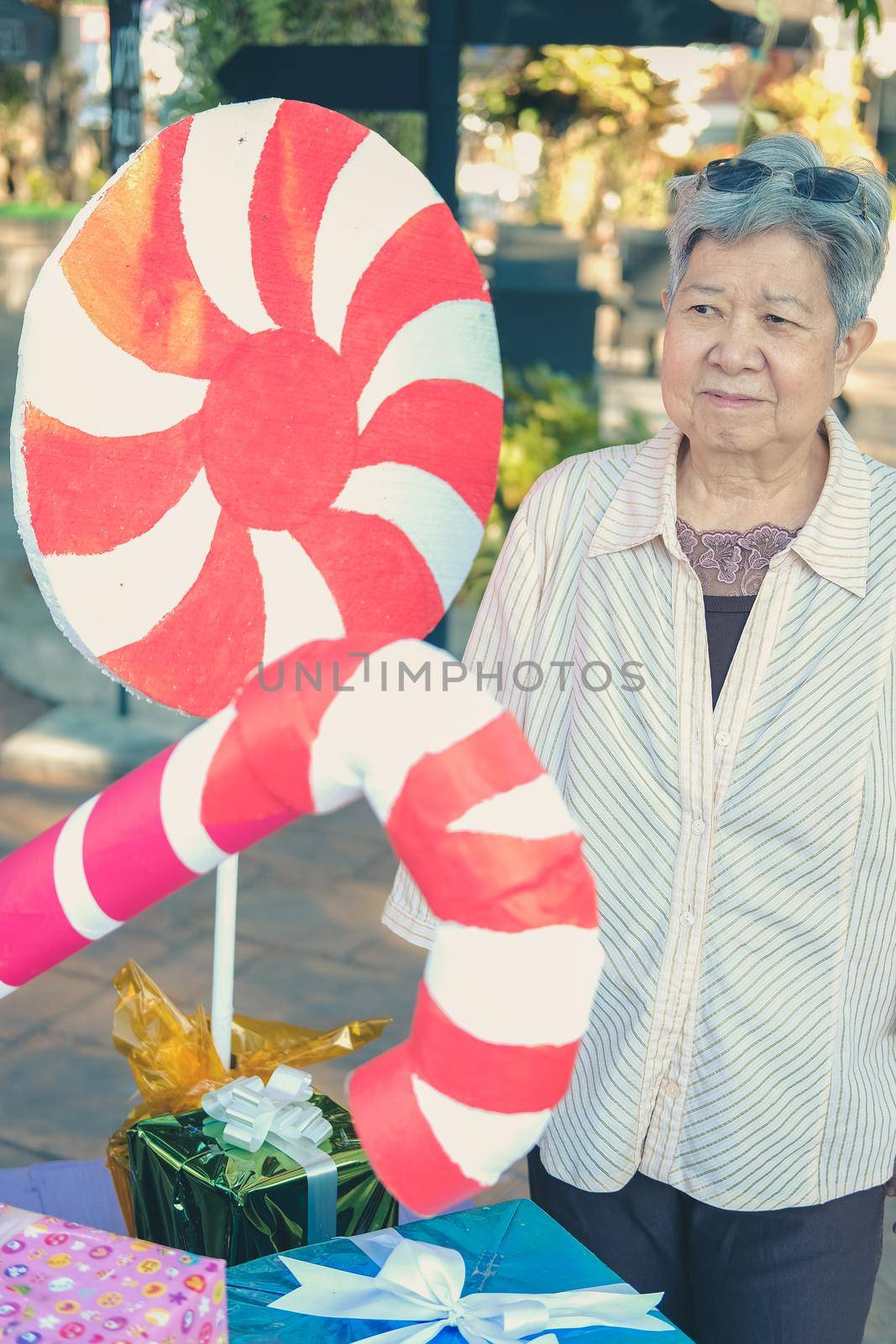 asian old elder woman elderly senior with decorative gift present box at christmas