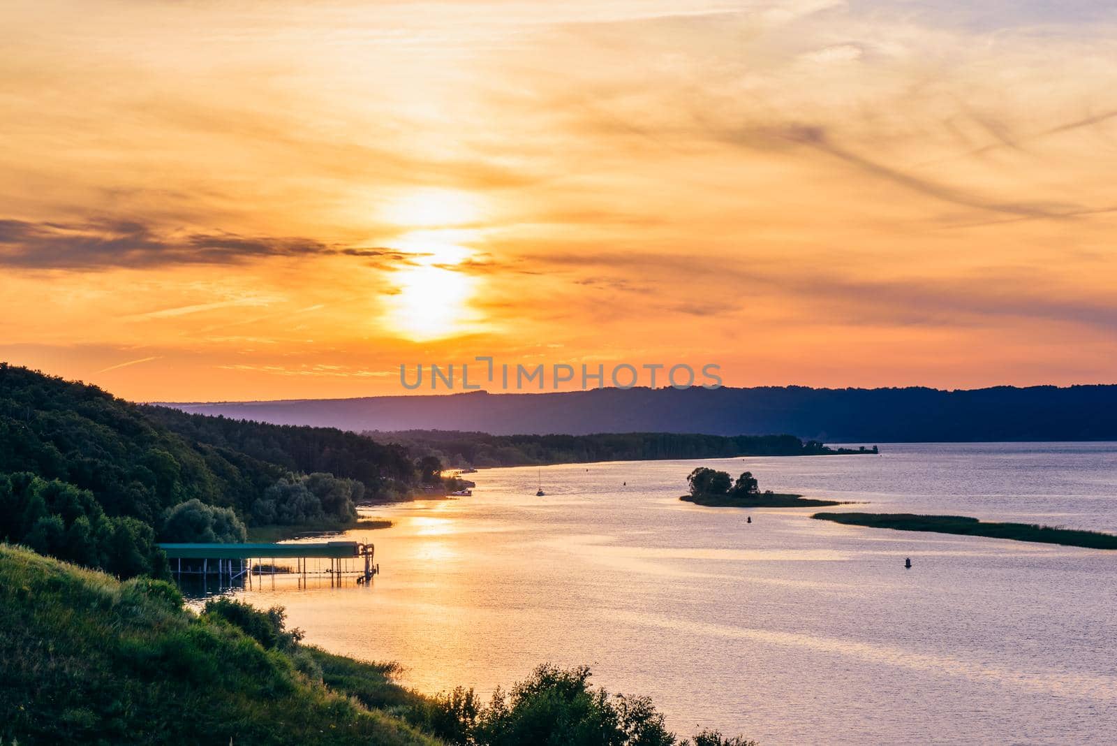 Summer sunset on river shore.