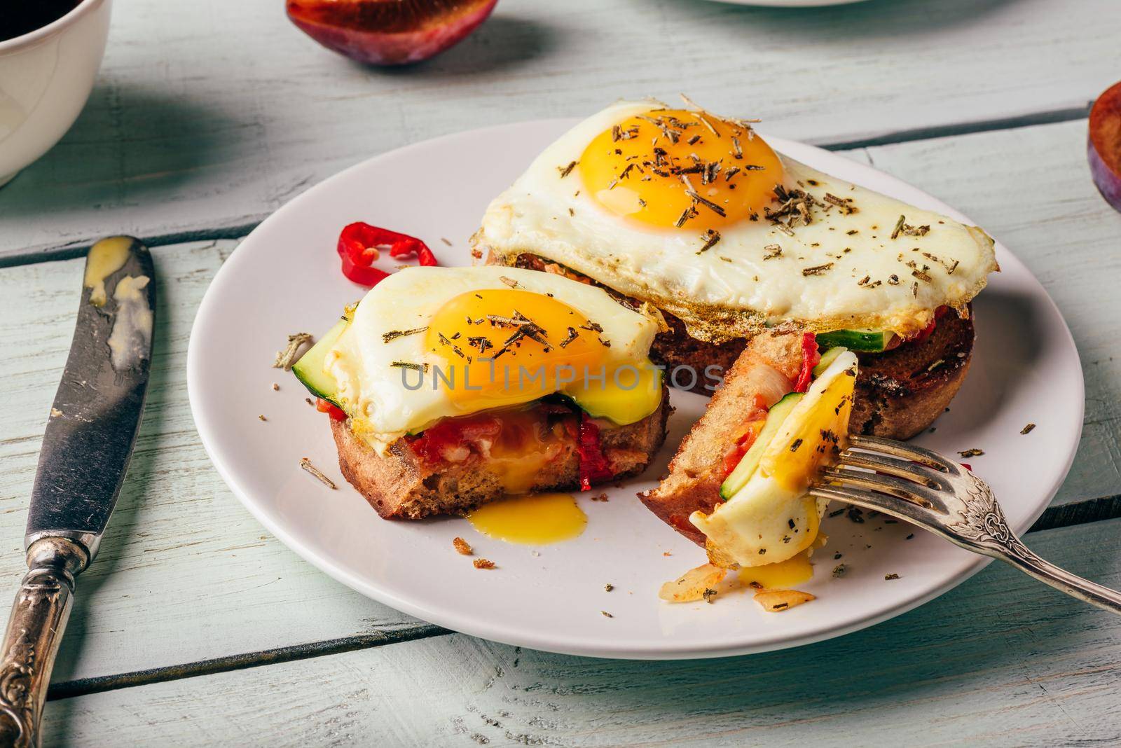 Sandwiches with vegetables and fried egg and cup of coffee by Seva_blsv