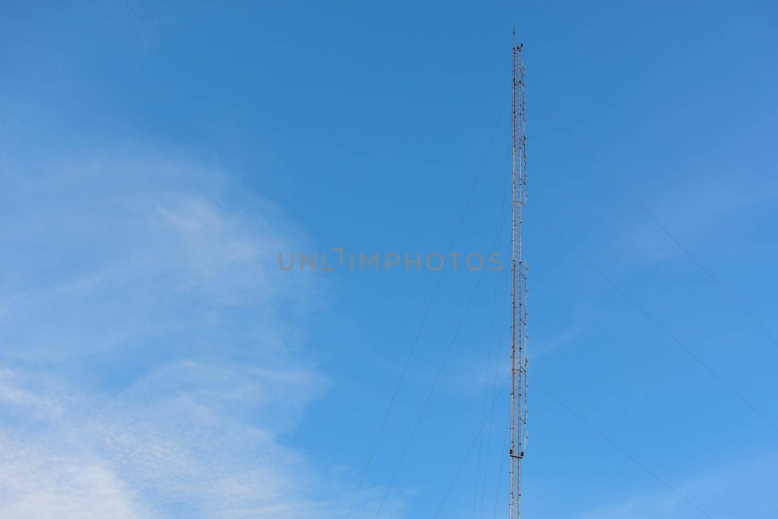 Phone antenna with blue sky background. by iPixel_Studio