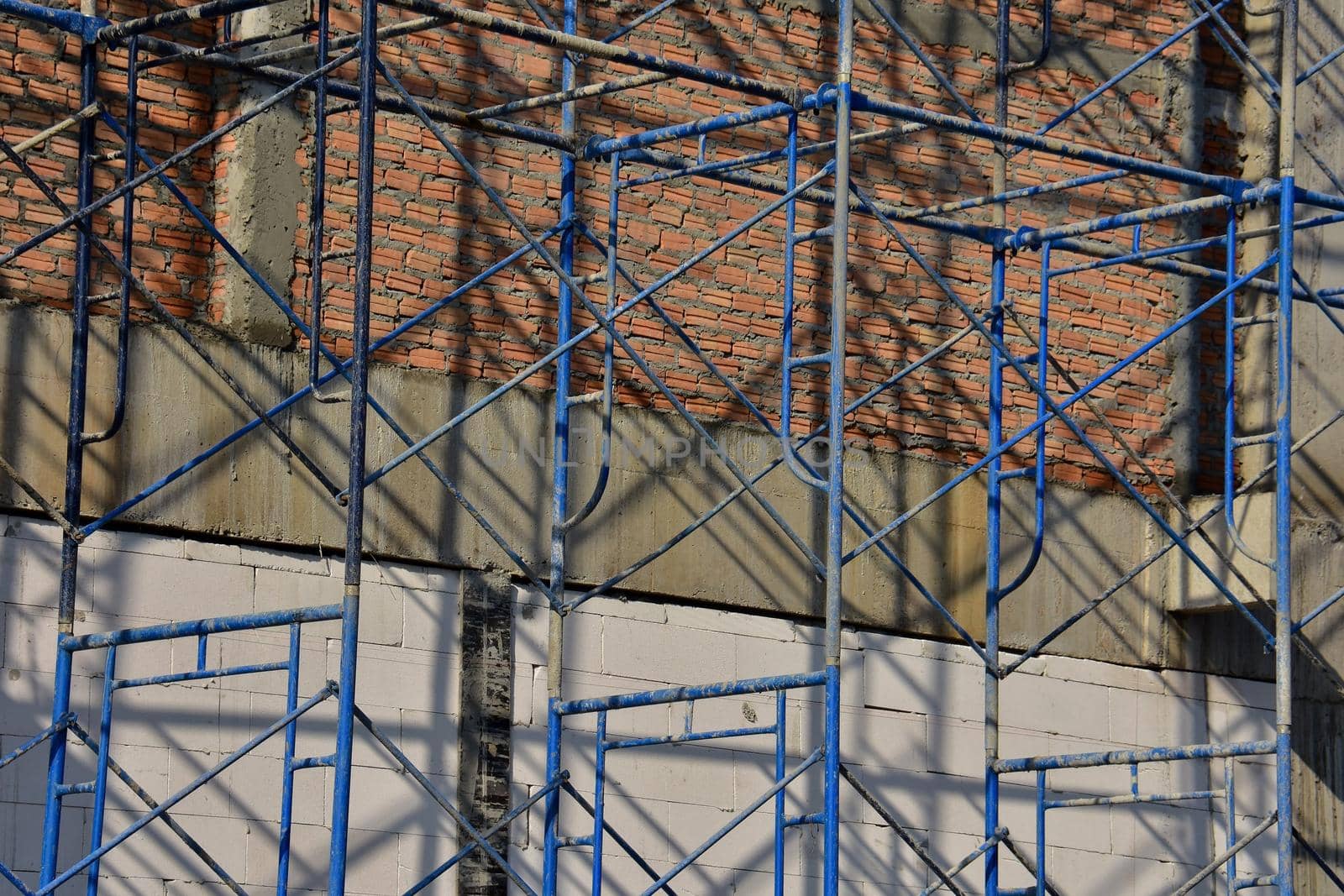 Scaffolding on a building under construction. by iPixel_Studio