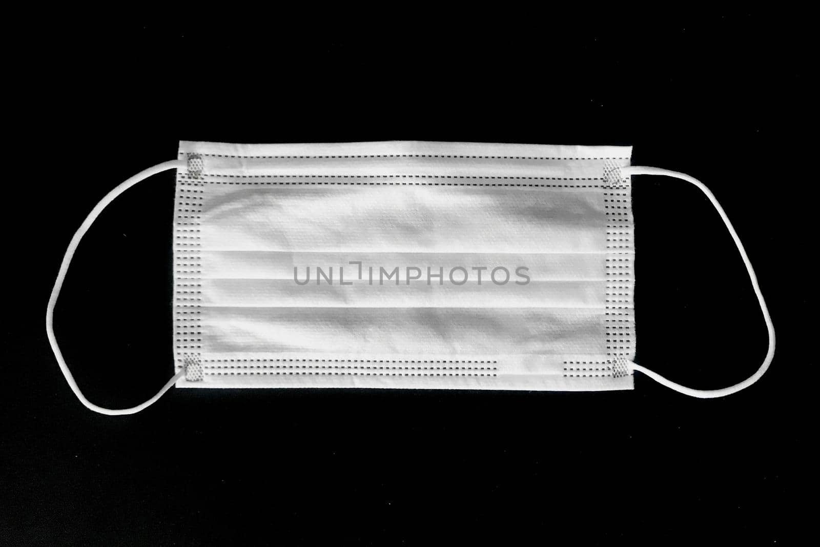 Disposable surgical mask on black background by iPixel_Studio