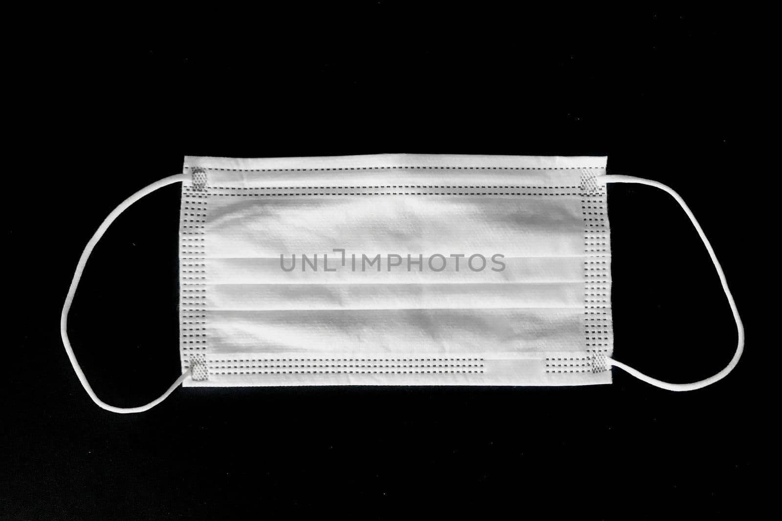 Disposable surgical mask on black background by iPixel_Studio