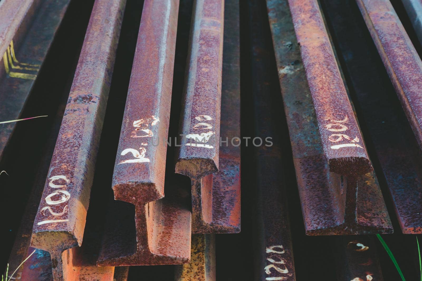 Steel tracks piled together beside the tracks