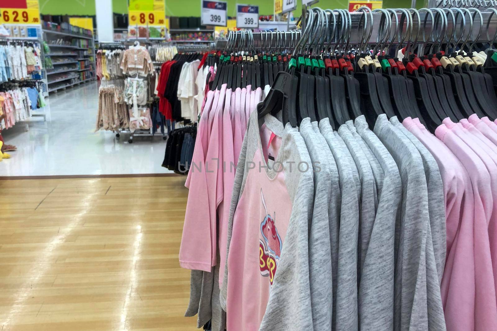 Clothes for children hanging for sale in the mall by iPixel_Studio