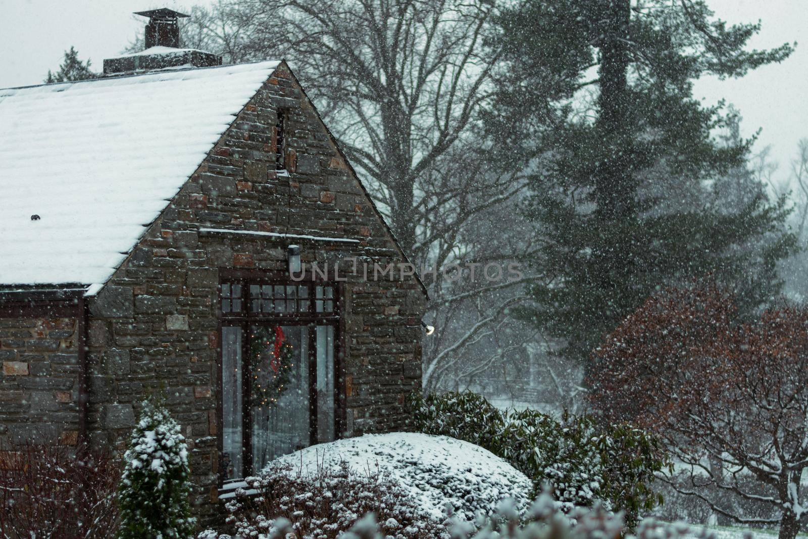 A Cobble Suburban Home and Street During a Snowstorm by bju12290