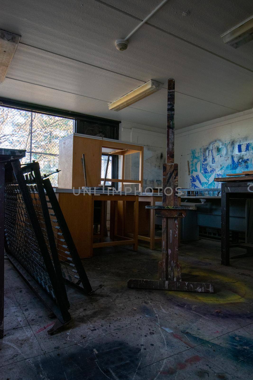 An Abandoned Art Studio in a School With an Easel In It by bju12290