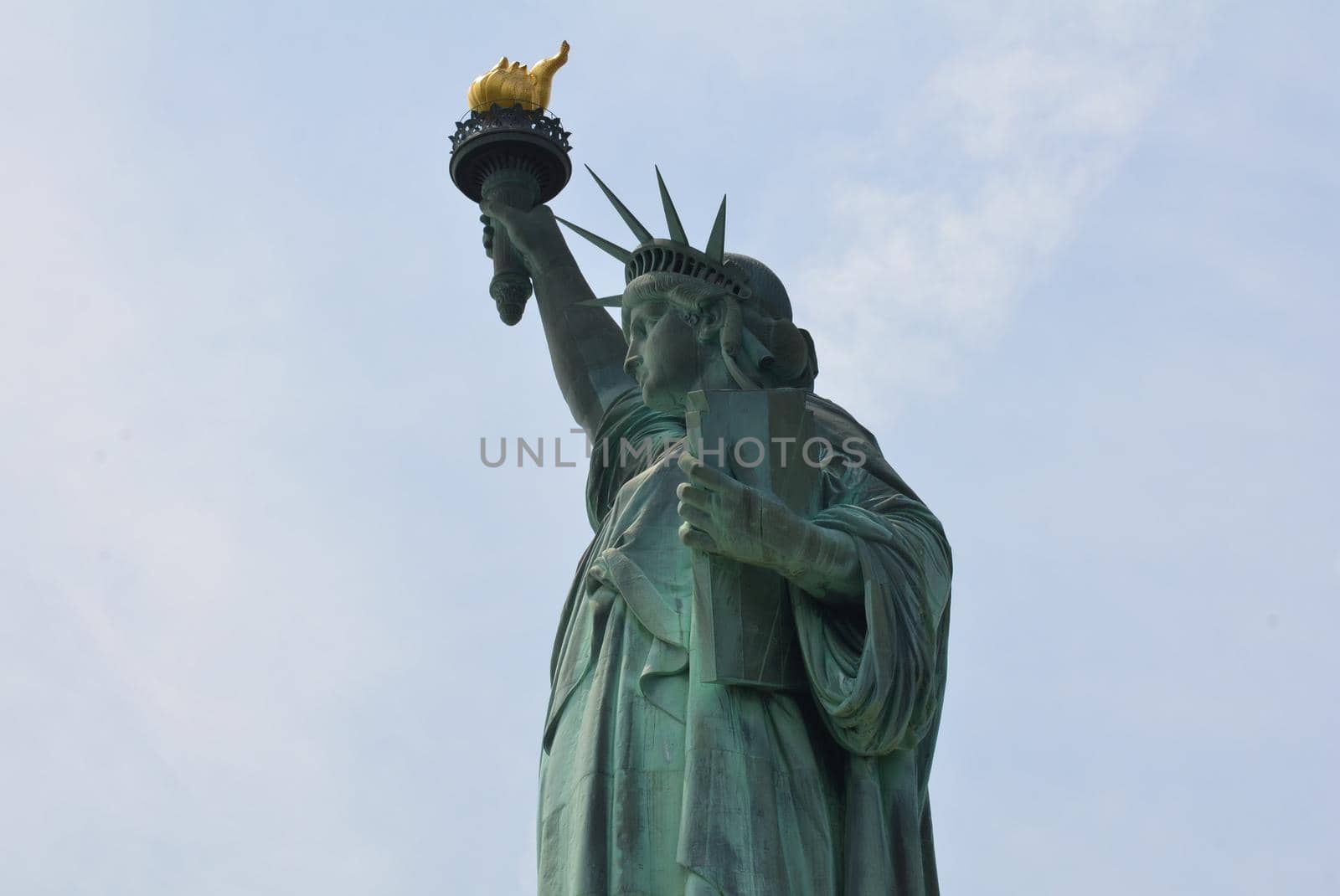 green copper statue of liberty landmark with torch in New York