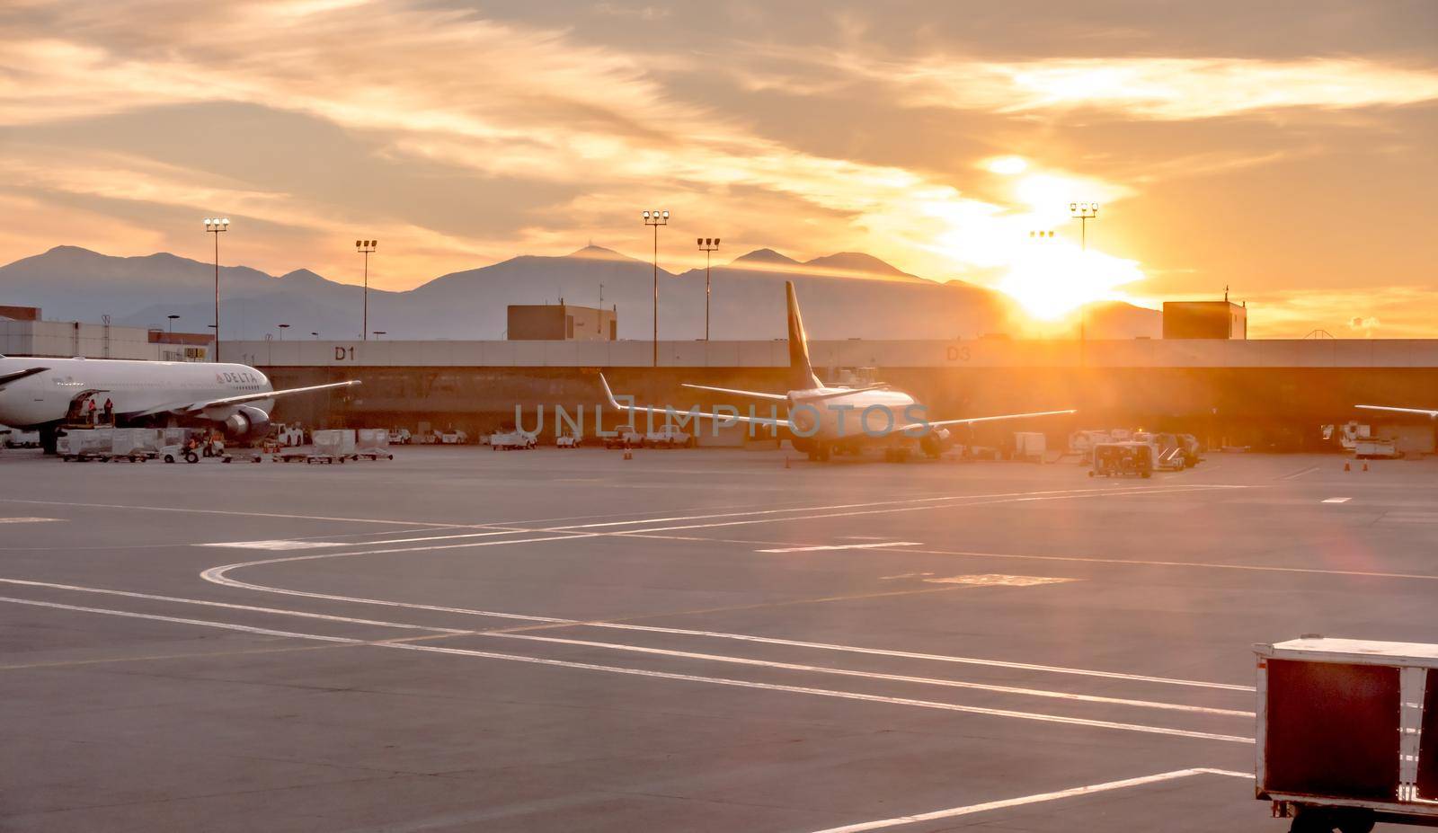 flying over rockies in airplane from salt lake city at sunset by digidreamgrafix