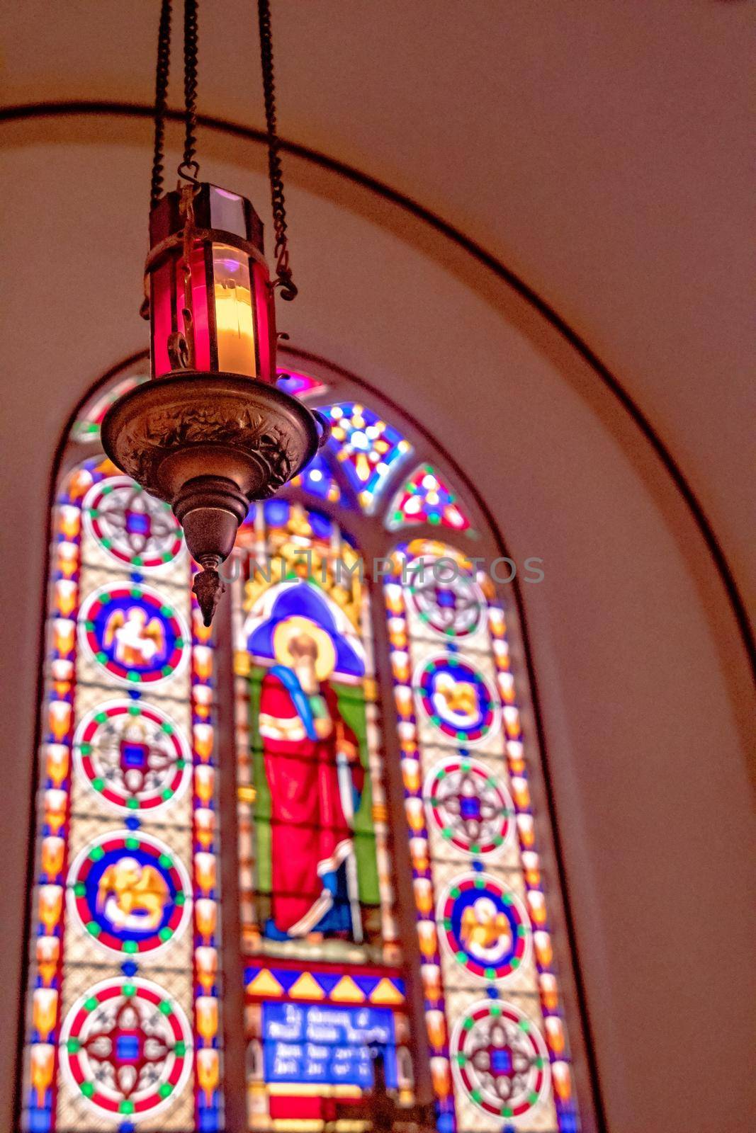 inside church worship house with stained galss windows and pedestal