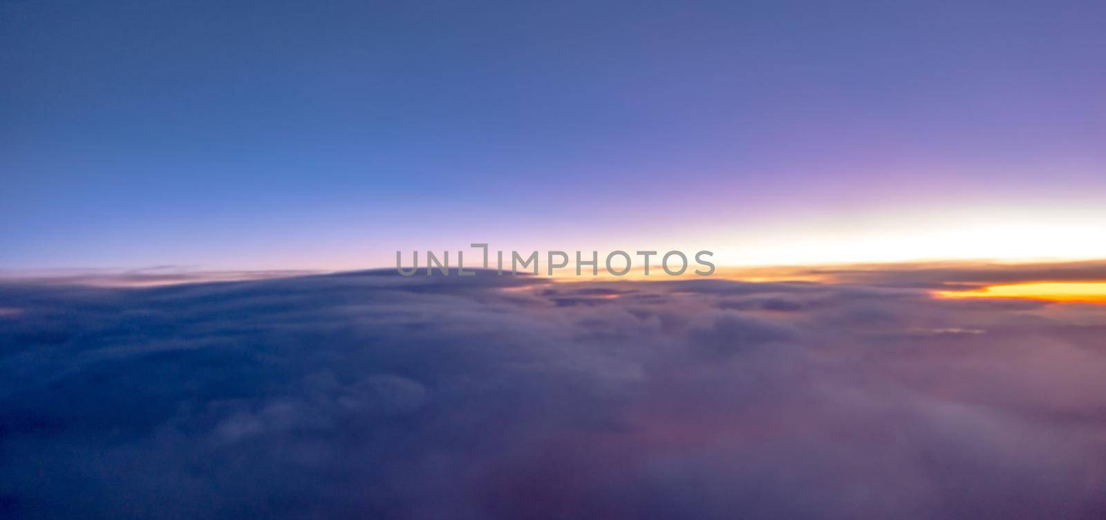 flying over rockies in airplane from salt lake city at sunset by digidreamgrafix