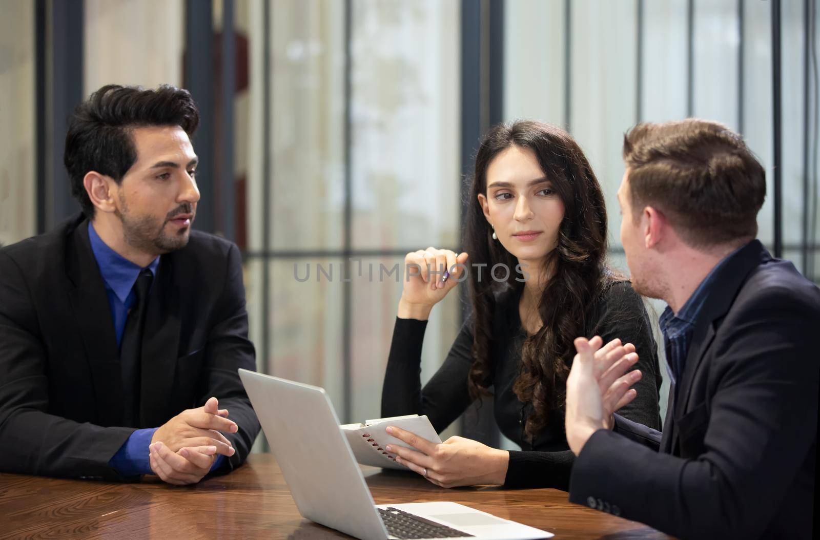 Young business team discussing and studying statistics in a meeting room