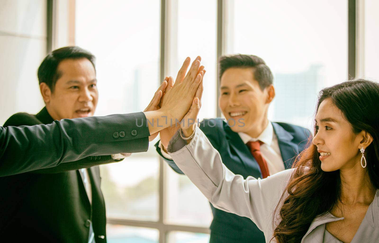 young business people putting their hands together. Stack of hands. Unity, teamwork concept by chuanchai