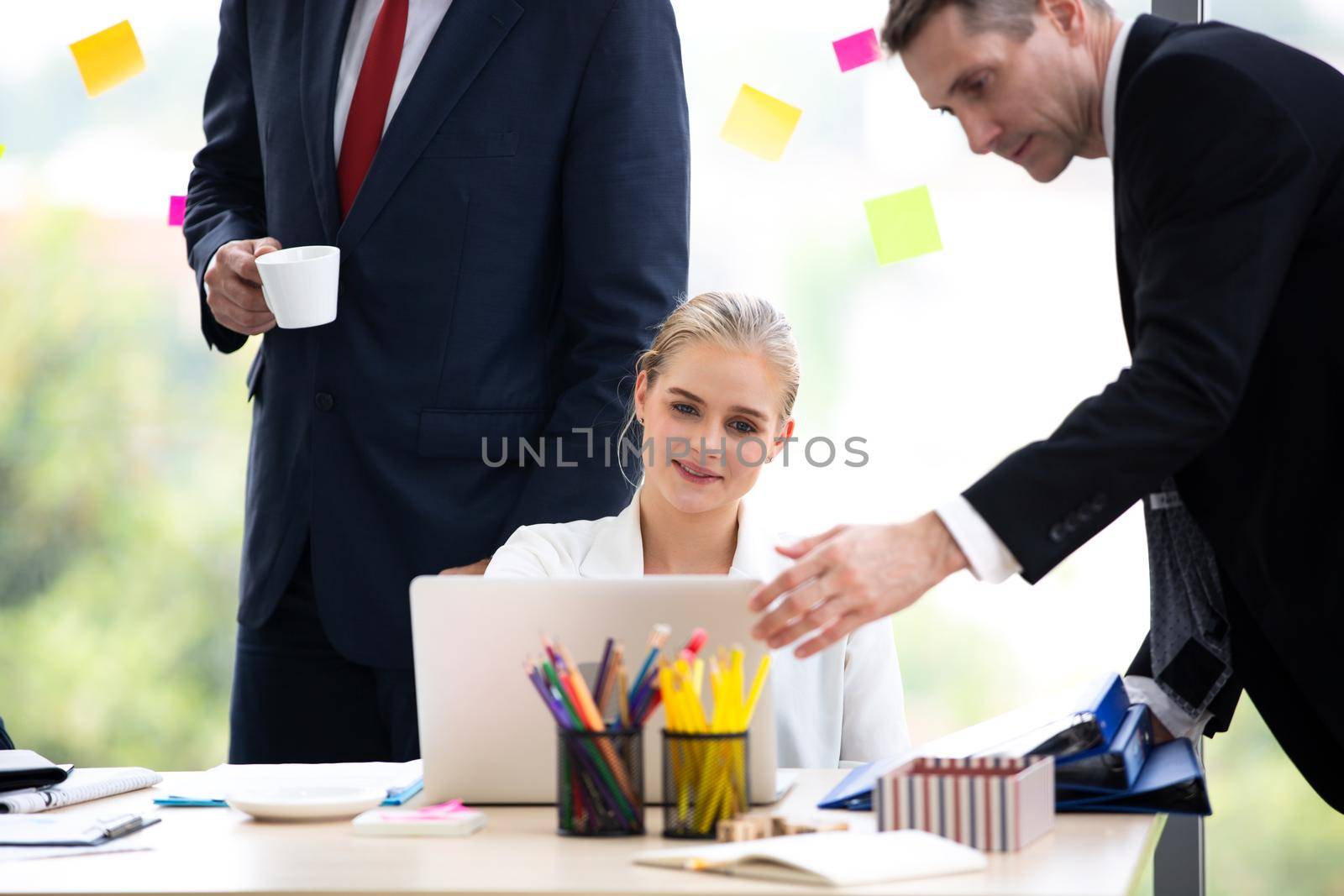 young business team working together at office. Manager pointing at a chart and explaining the analysis about business strategies. Top view shot of business hand shake