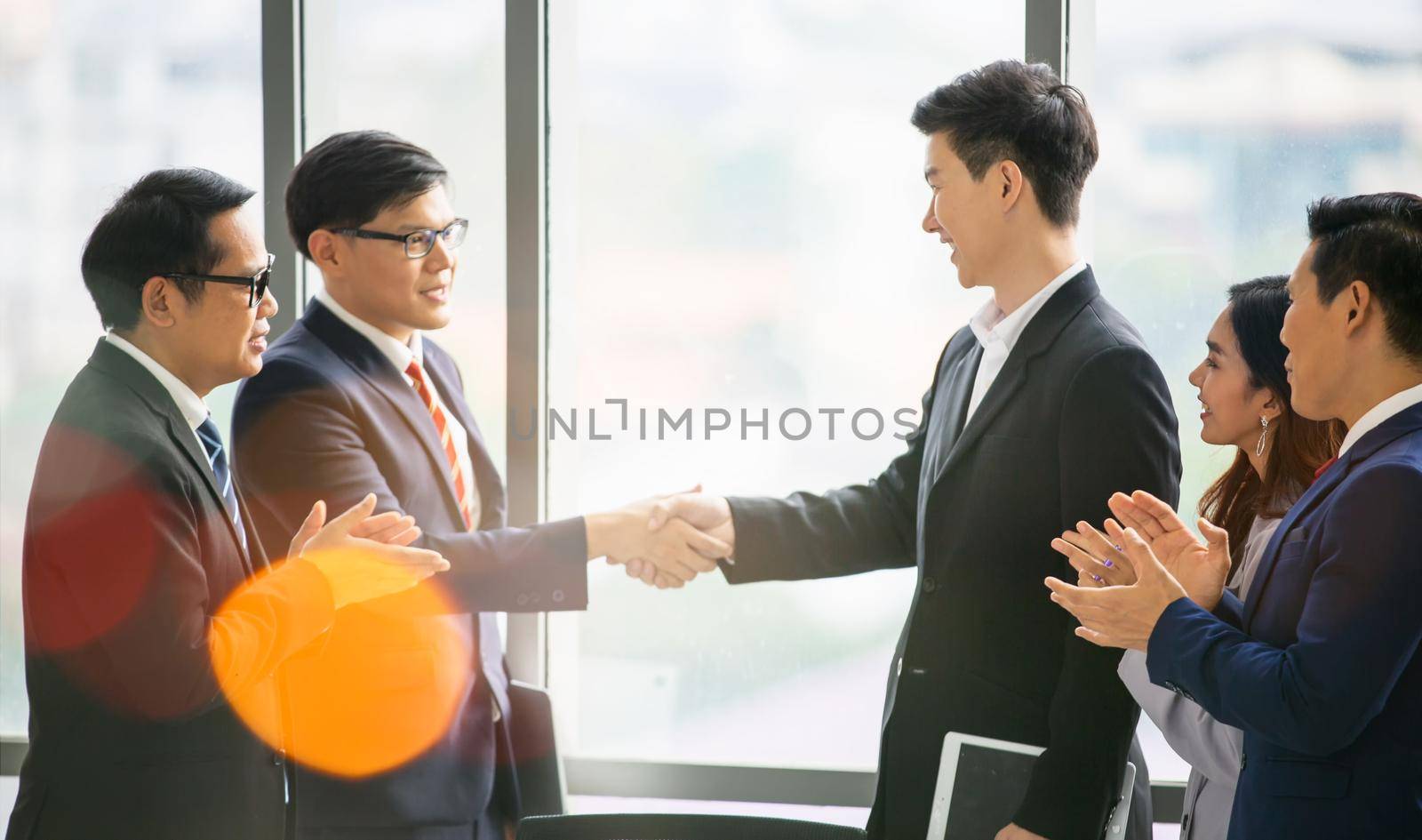 Business people give hands stack or holding each other for Unity and teamwork concept.