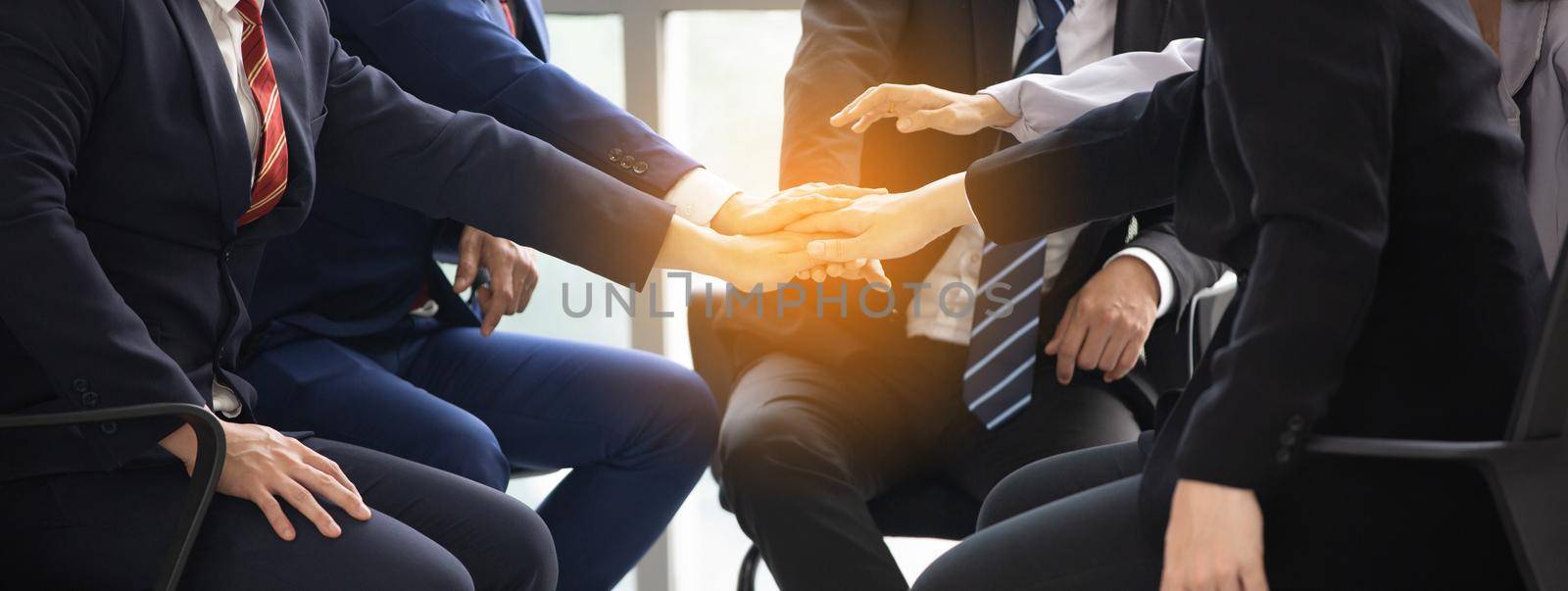 Business people shaking hands in the modern office finishing successful meeting by chuanchai