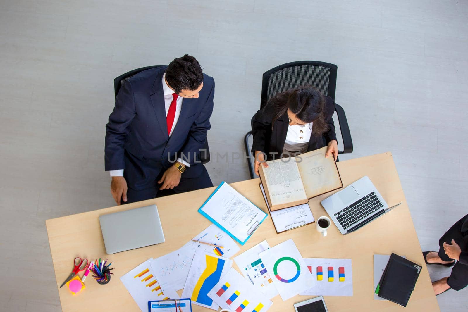 Top view on a group of businessman and businesswoman having a meeting and making a business commitment.