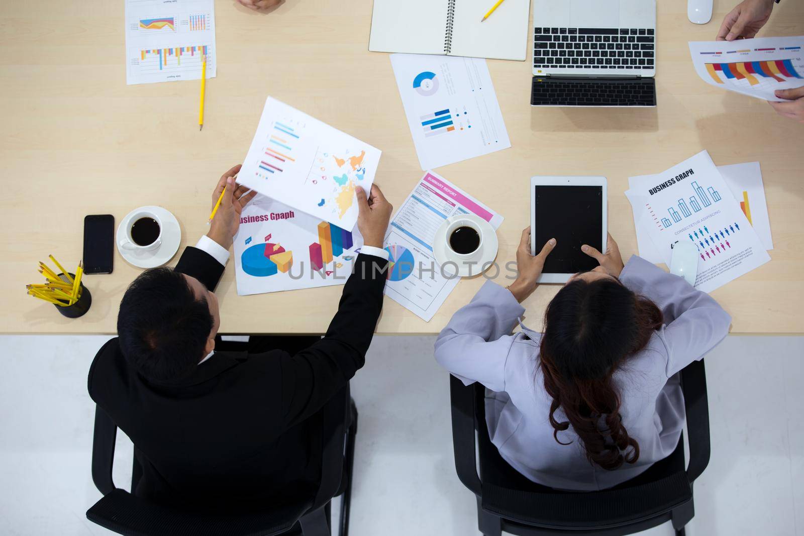 Top view on a group of businessman and businesswoman having a meeting and making a business commitment.