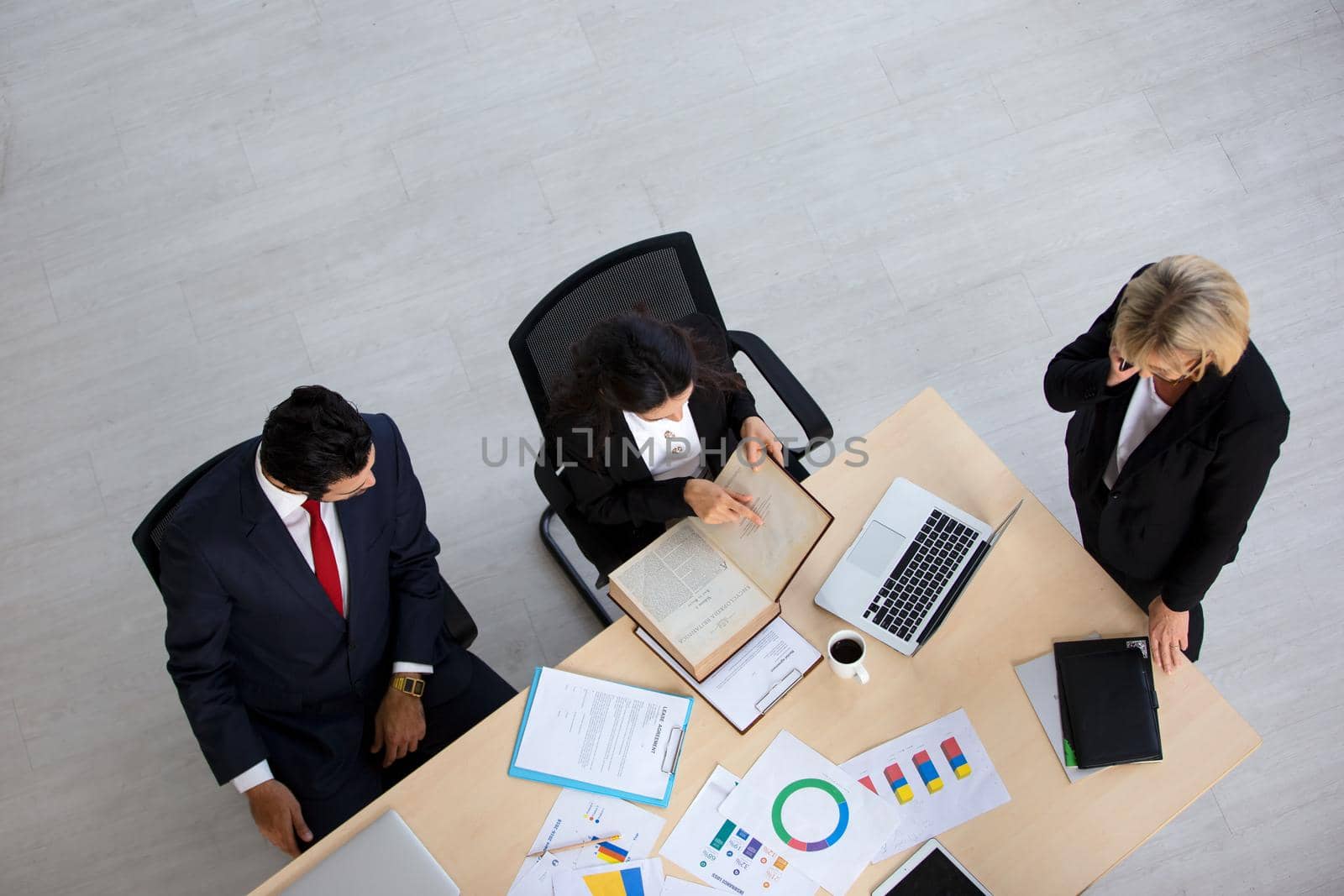 Top view on a group of businessman and businesswoman having a meeting and making a business commitment.