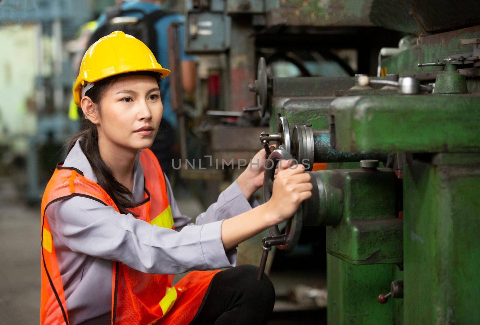 Female Engineers operating a cnc machine in factory