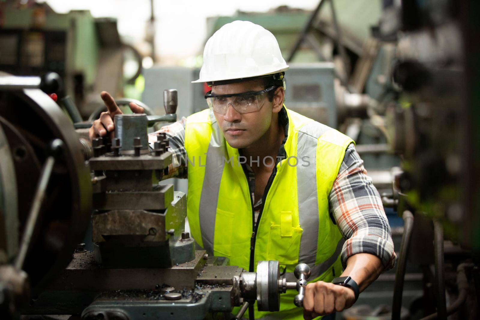 Engineers operating a cnc machine in factory