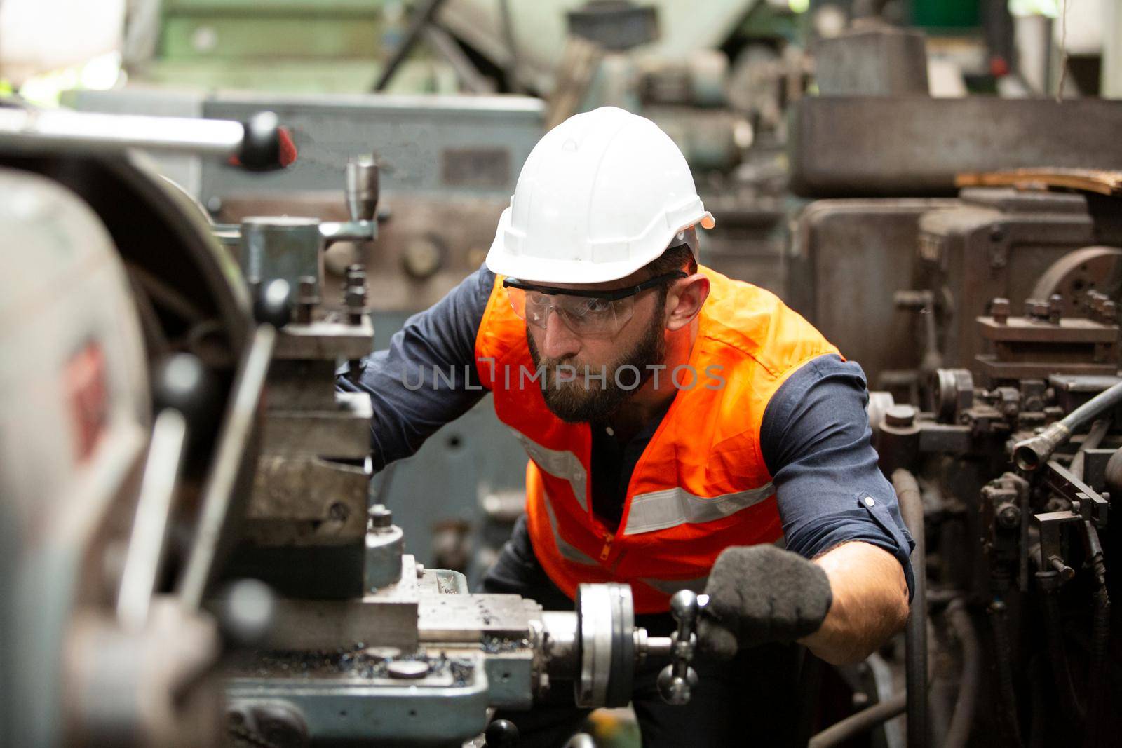 Engineers operating a cnc machine in factory