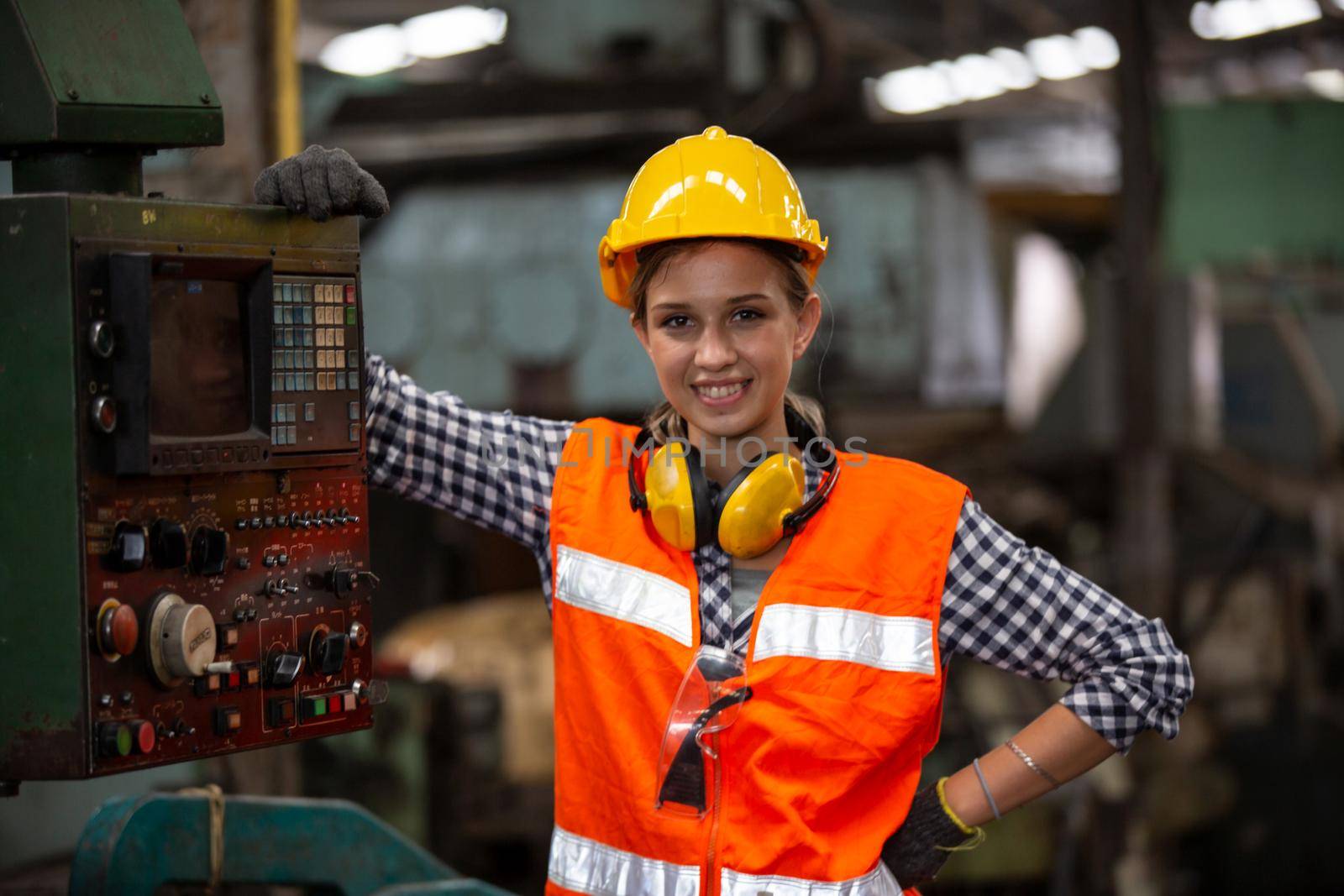 Female Engineers operating a cnc machine in factory