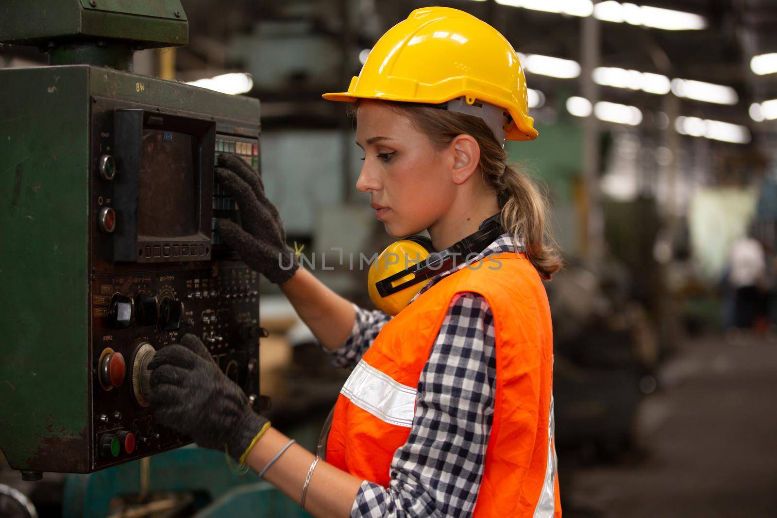 Female Engineers operating a cnc machine in factory