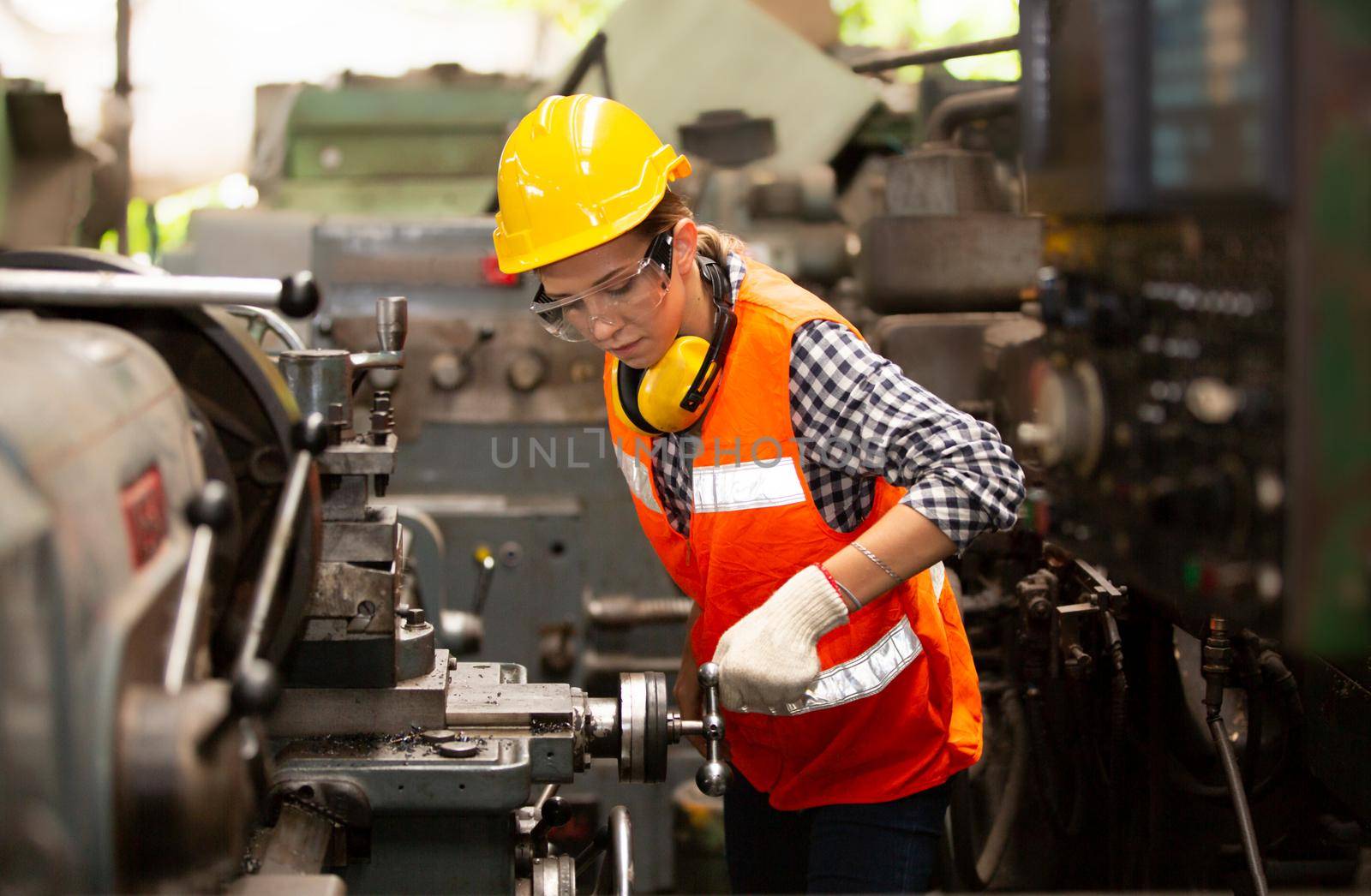 Female Engineers operating a cnc machine in factory