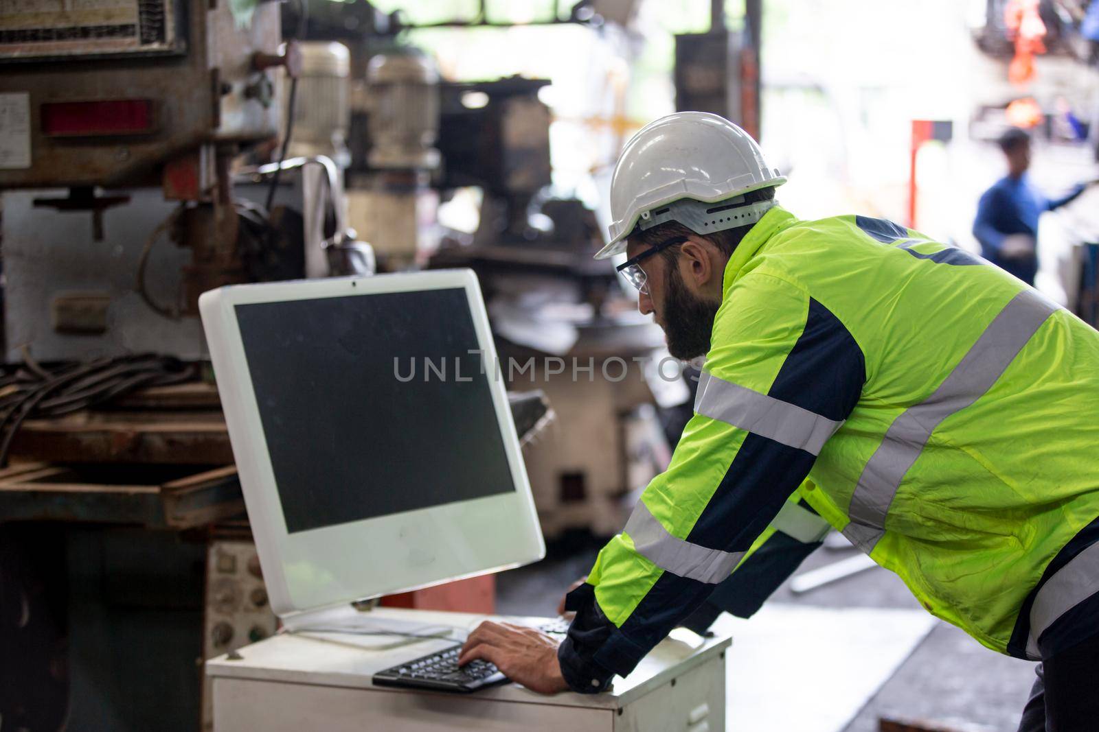 construction worker using laptop, Engineer standing with confident against machine environment in factory