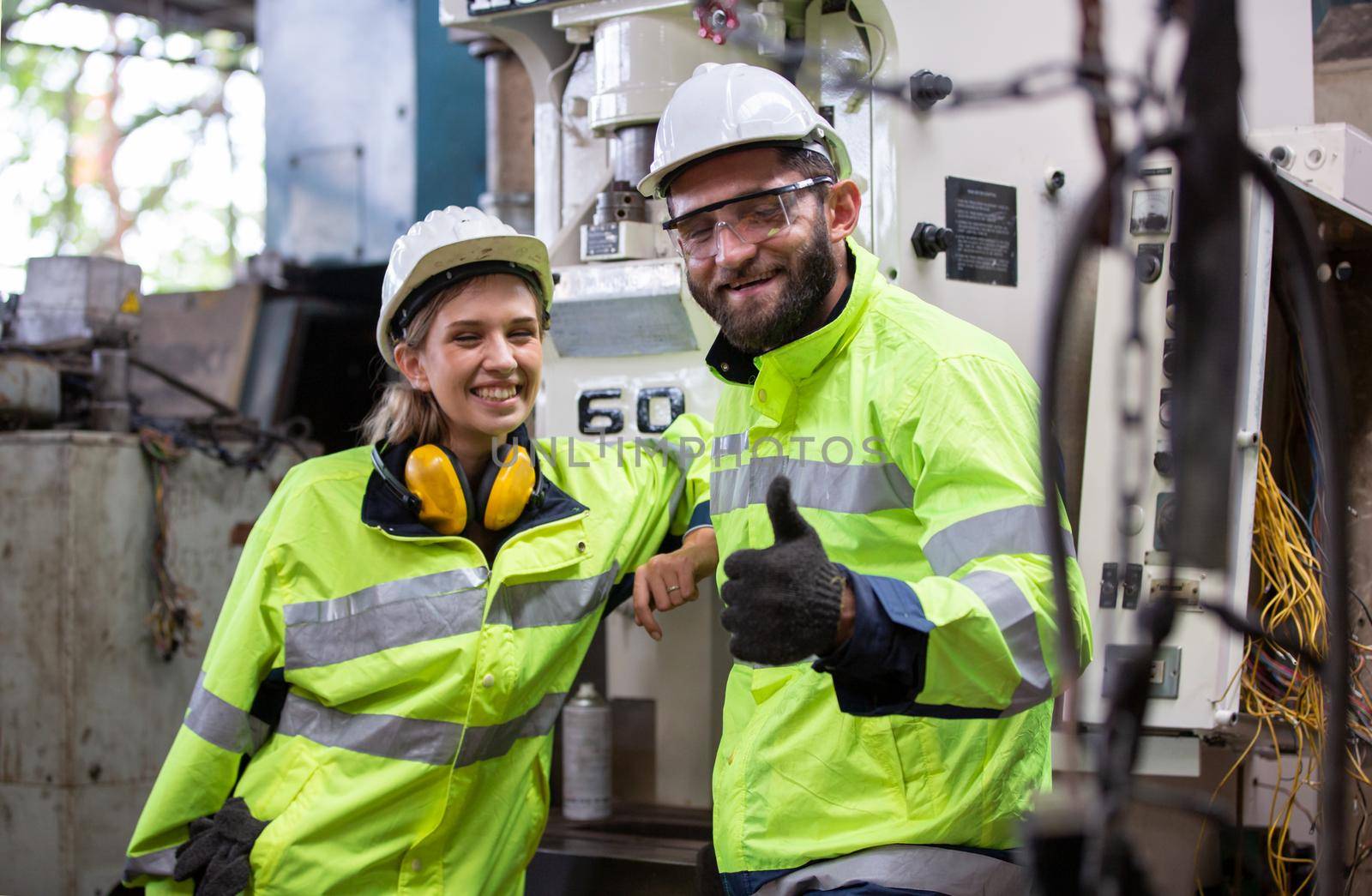 Portrait of female Engineer standing with confident against machine environment in factory, Engineers operating a machine in factory by chuanchai