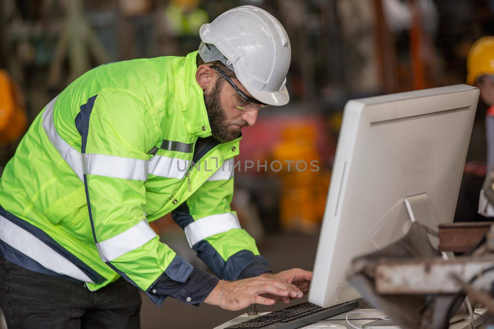 construction worker using laptop, Engineer standing with confident against machine environment in factory	
