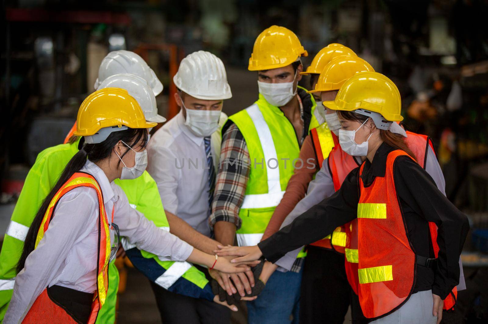 Male Industrial Engineers Talk with Factory Worker . They Work at the Heavy Industry Manufacturing Facility. by chuanchai