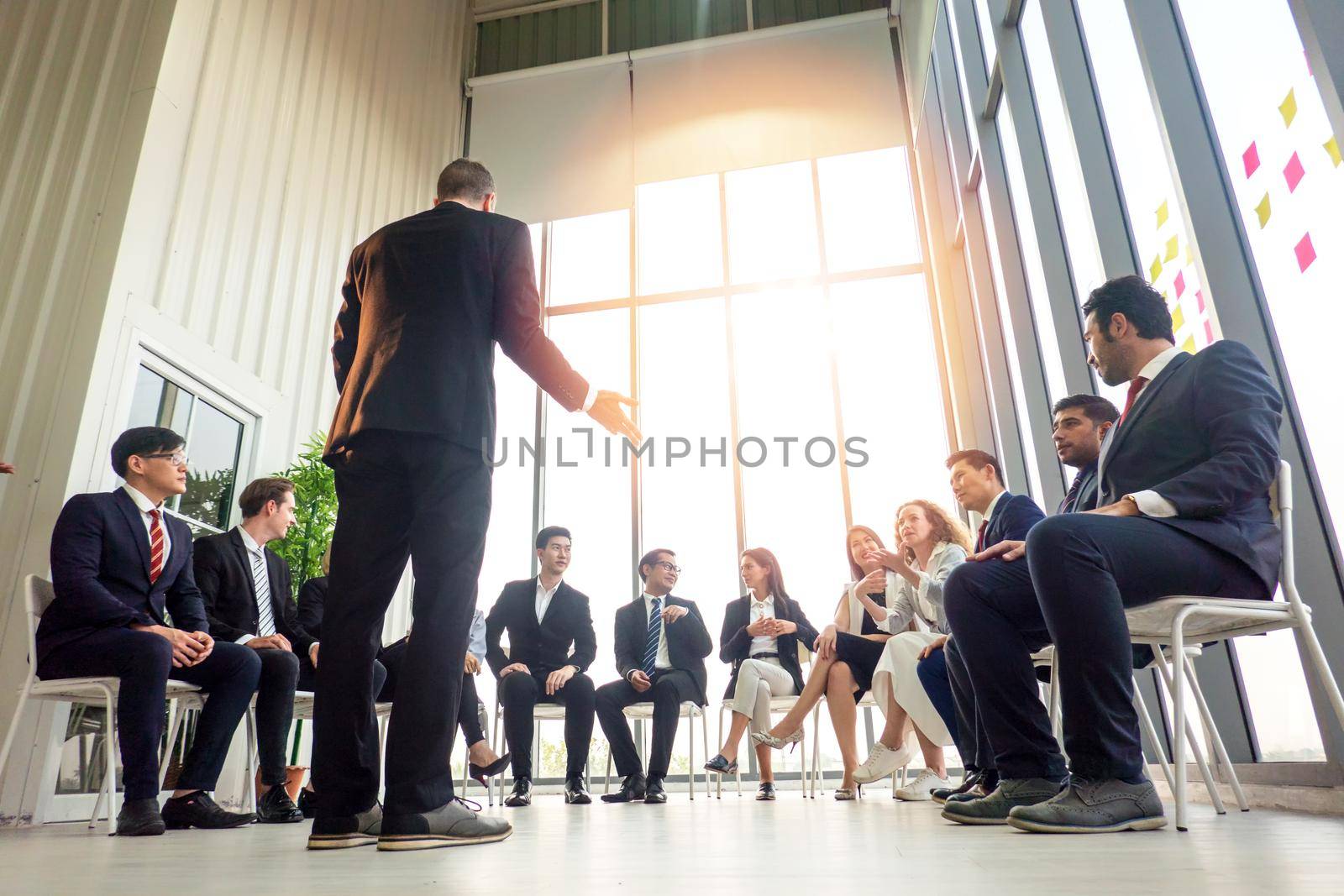 Business people talking at group meeting. by chuanchai