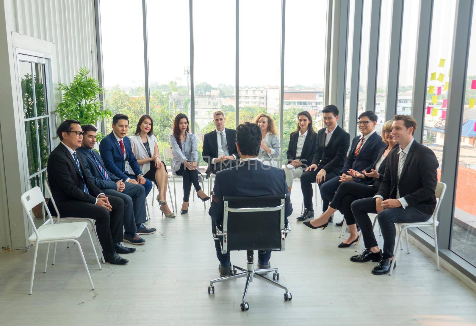 Business people talking at group meeting. by chuanchai