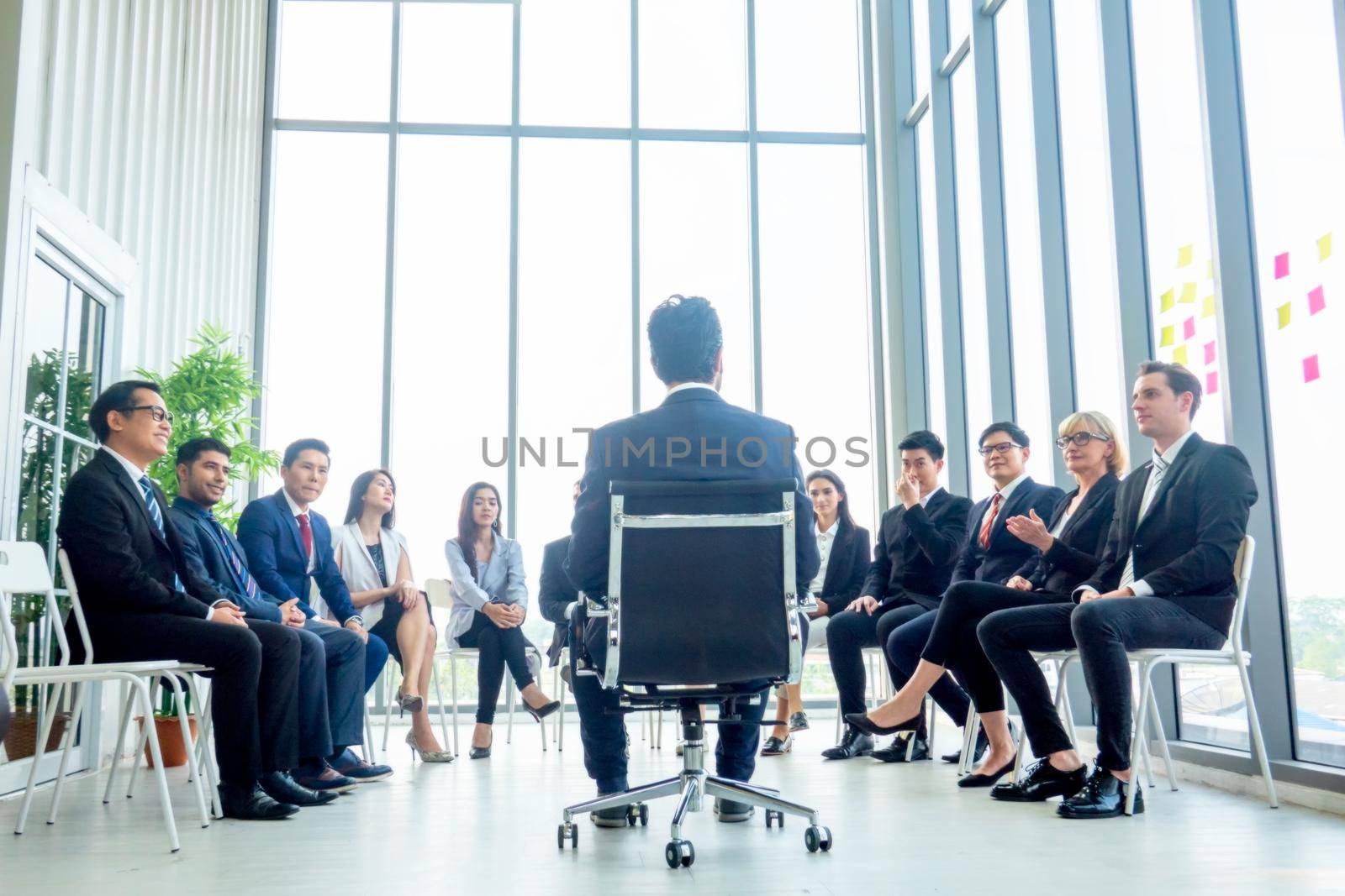 Business people talking at group meeting. by chuanchai