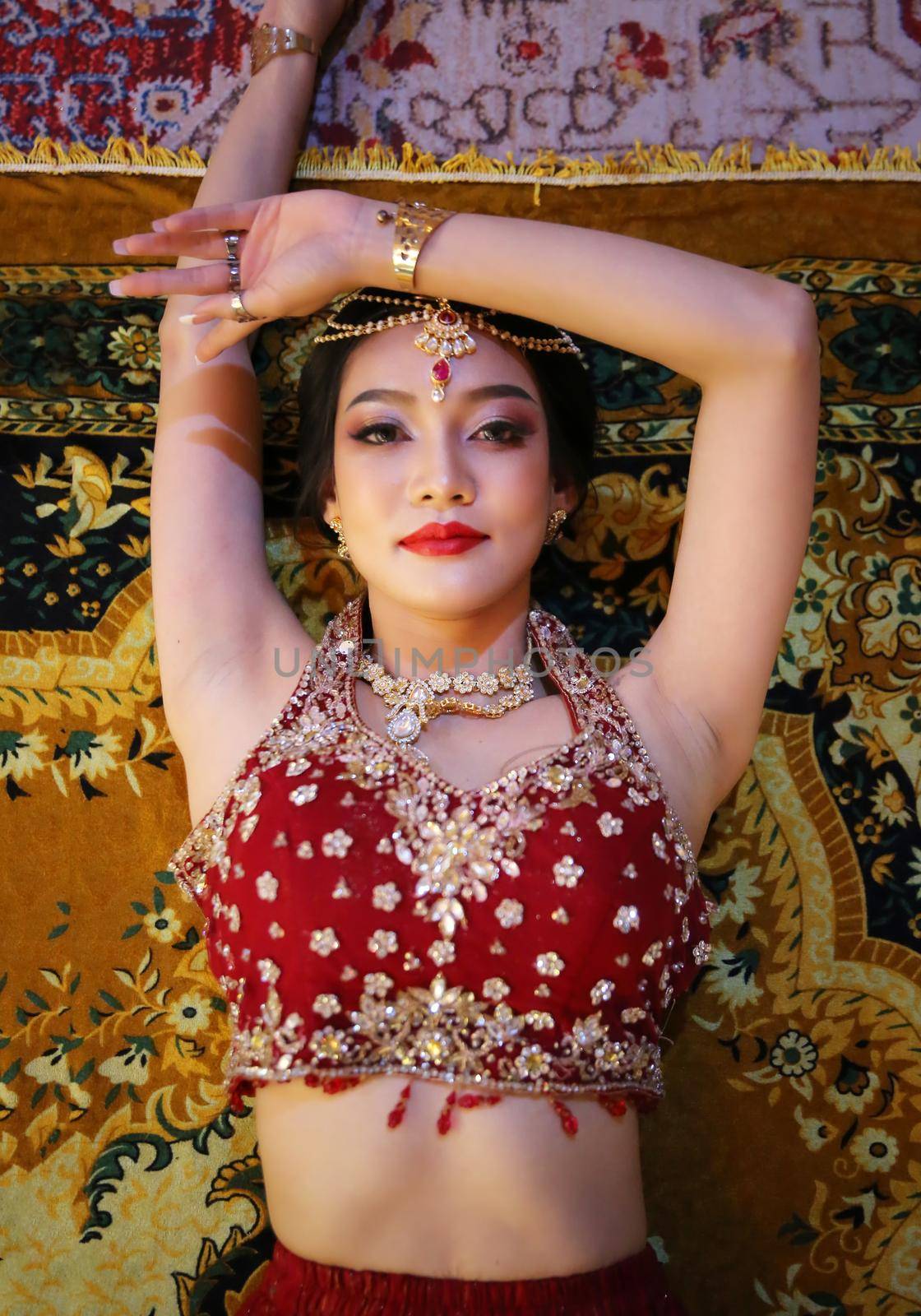 Portrait of beautiful indian girl . Young hindu woman model in sari and kundan jewelry . Traditional India costume lehenga choli . Eastern or Arabic culture. by chuanchai