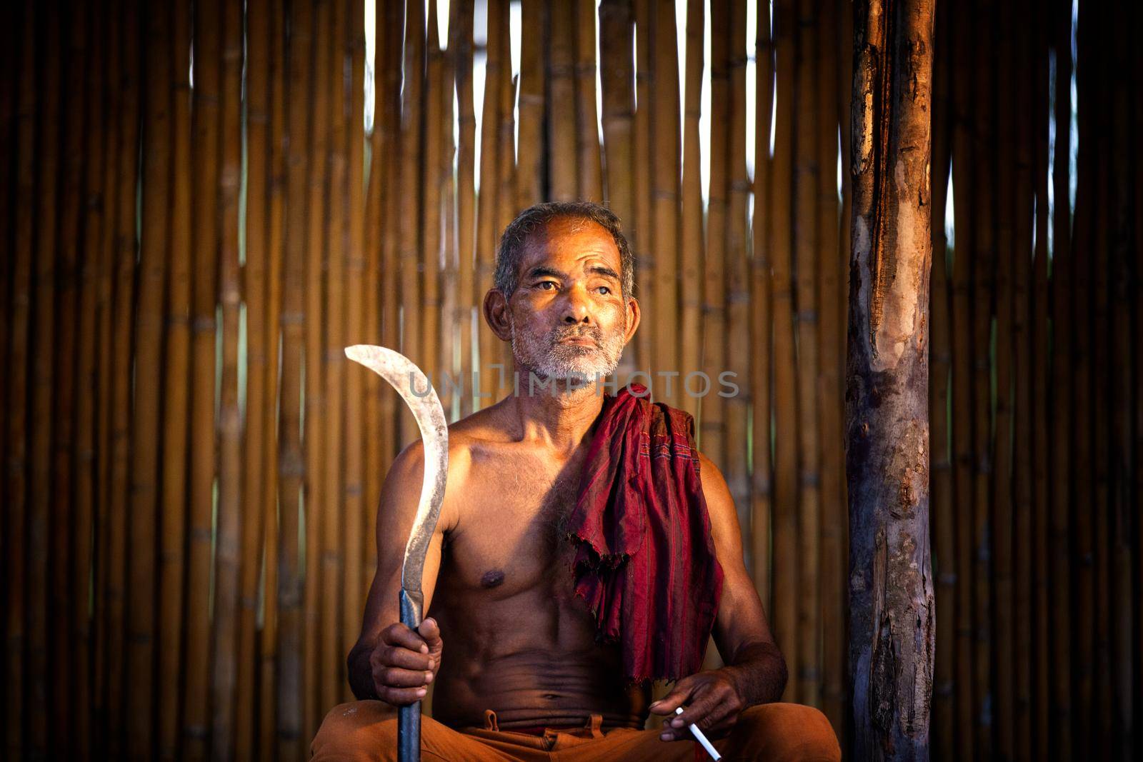 dark and sullen shot of a old man smoking over a black background