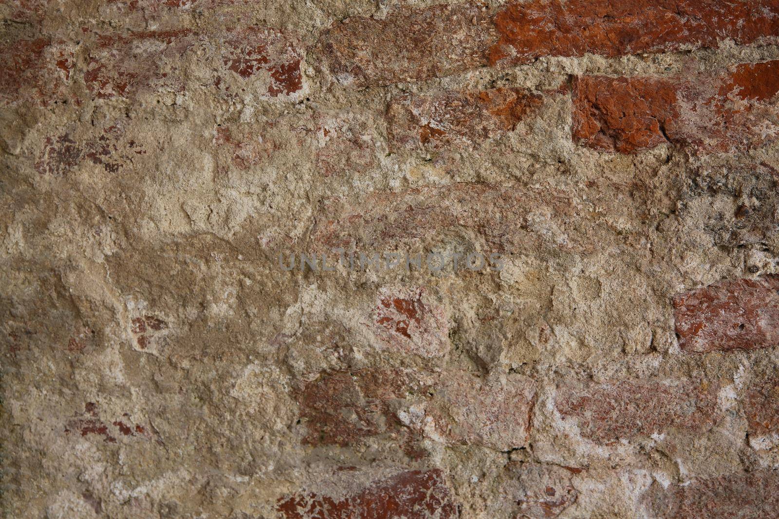abstract part of the old brick wall with ruined plaster for vintage background by chuanchai