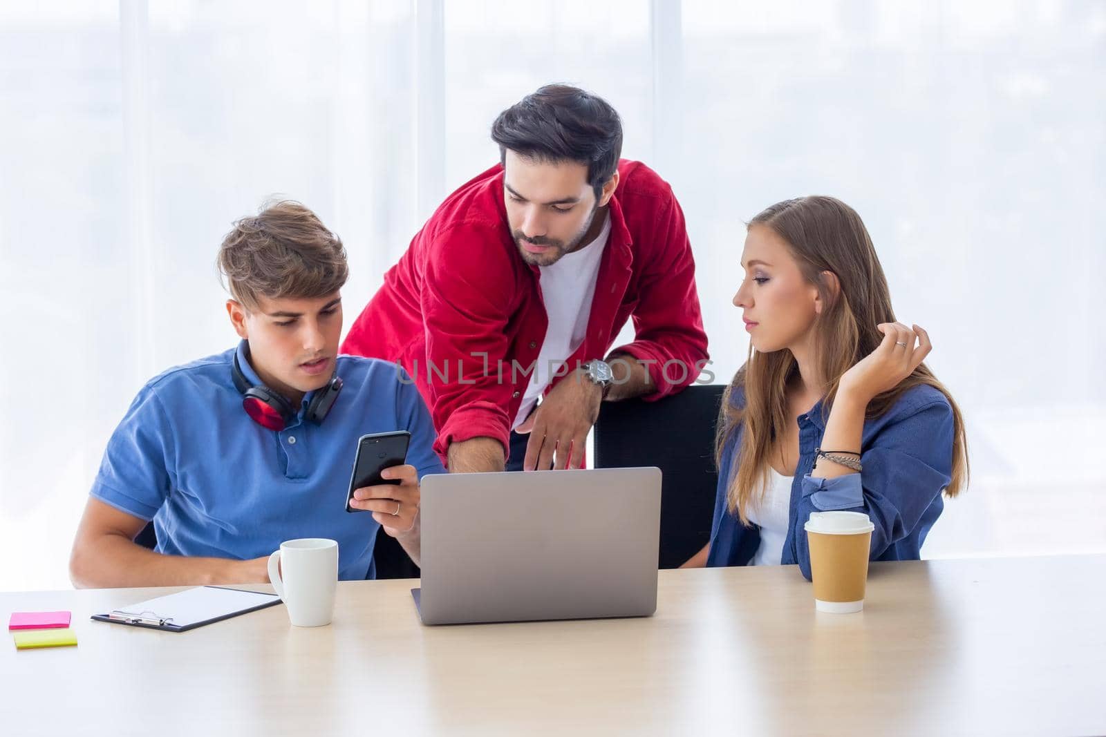 Business people working in office on desktop computer, Group of happy business people in smart casual wear looking at the laptop and gesturing. Achieving success. by chuanchai