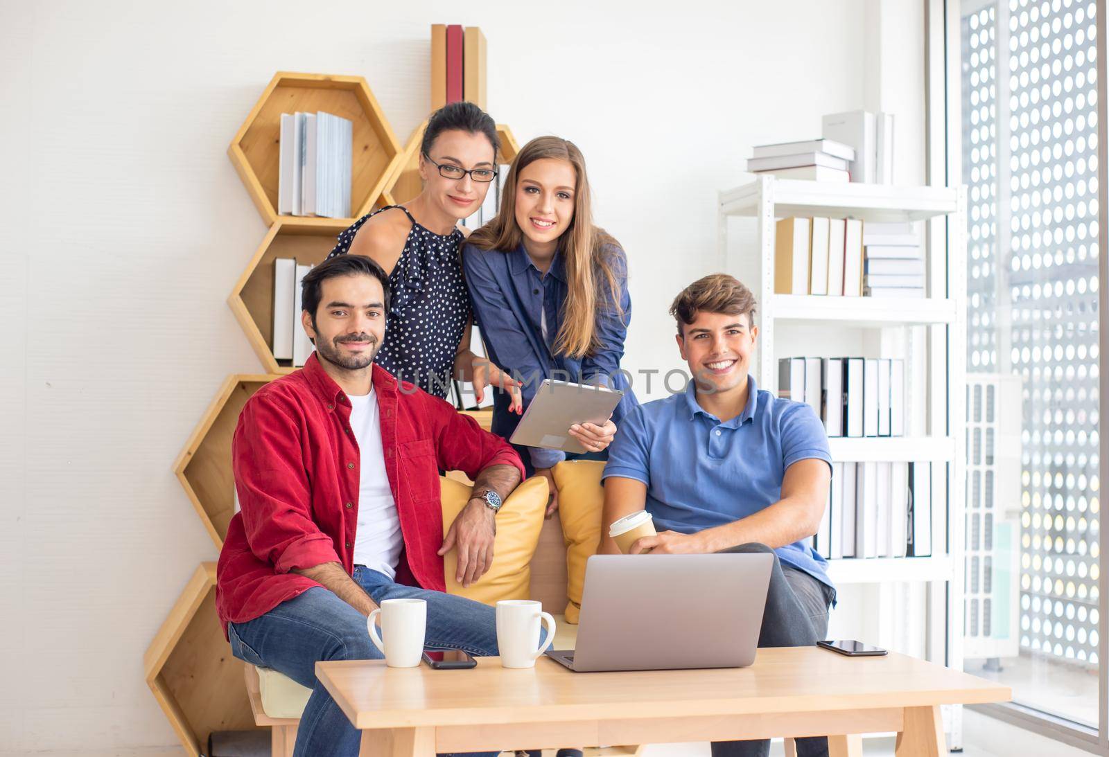 Business people working in office on desktop computer, Group of happy business people in smart casual wear looking at the laptop and gesturing. Achieving success. by chuanchai