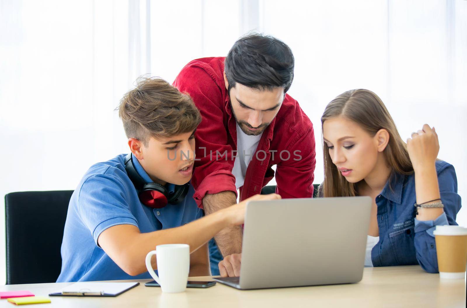 Business people working in office on desktop computer, Group of happy business people in smart casual wear looking at the laptop and gesturing. Achieving success. by chuanchai