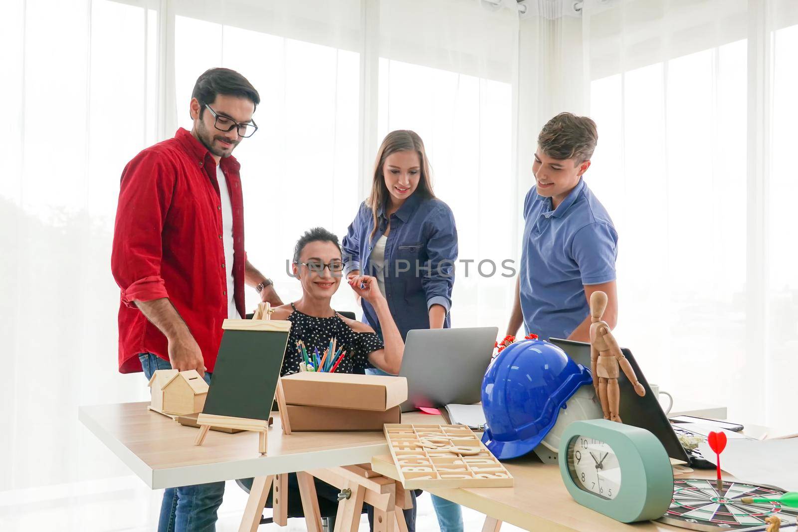 Business people working in office on desktop computer, Group of happy business people in smart casual wear looking at the laptop and gesturing. Achieving success. by chuanchai