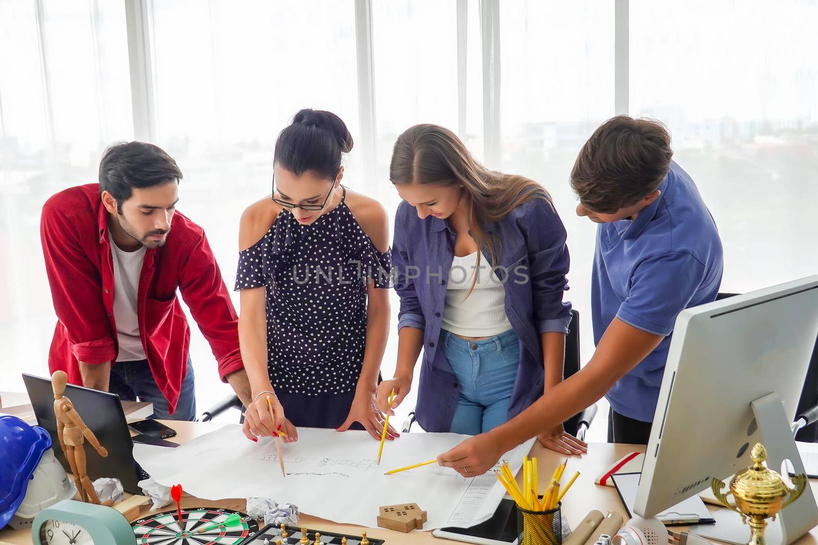 Business people working in office on desktop computer, Group of happy business people in smart casual wear looking at the laptop and gesturing. Achieving success. by chuanchai