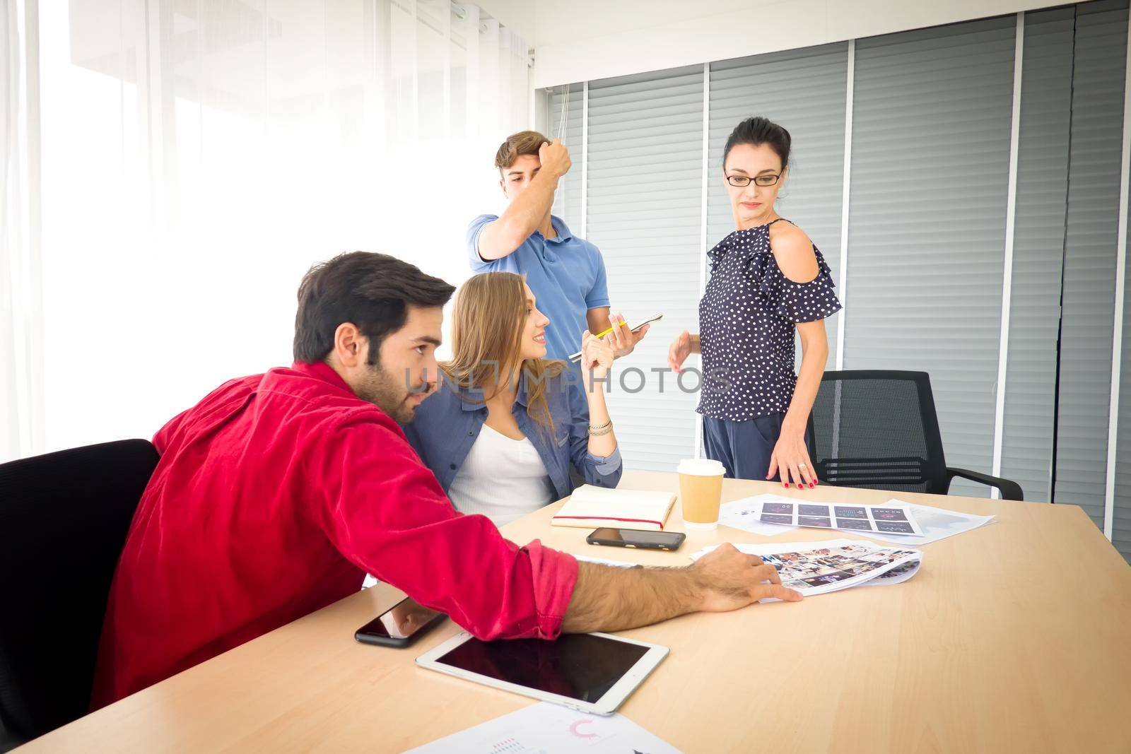 Business people working in office on desktop computer, Group of happy business people in smart casual wear looking at the laptop and gesturing. Achieving success. by chuanchai