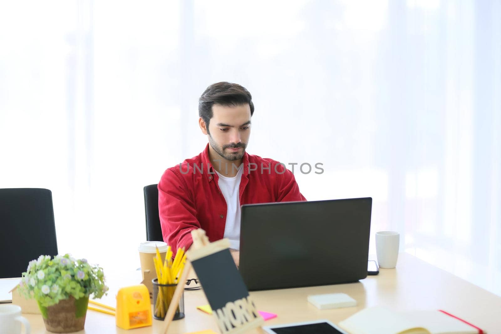 Business people working in office on desktop computer, Group of happy business people in smart casual wear looking at the laptop and gesturing. Achieving success.