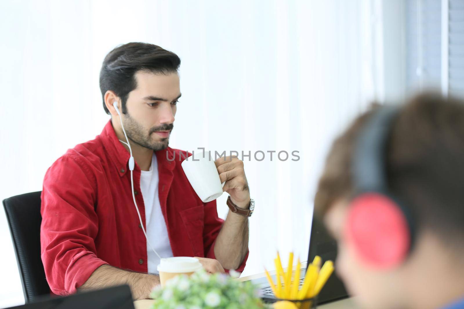 Business people working in office on desktop computer, Group of happy business people in smart casual wear looking at the laptop and gesturing. Achieving success.